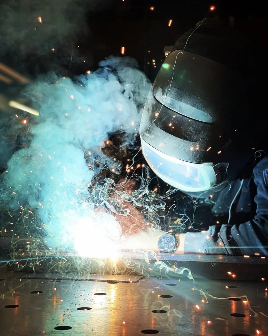 Het lassen van een lantaarnonderdeel in de werkplaats van Artisans.